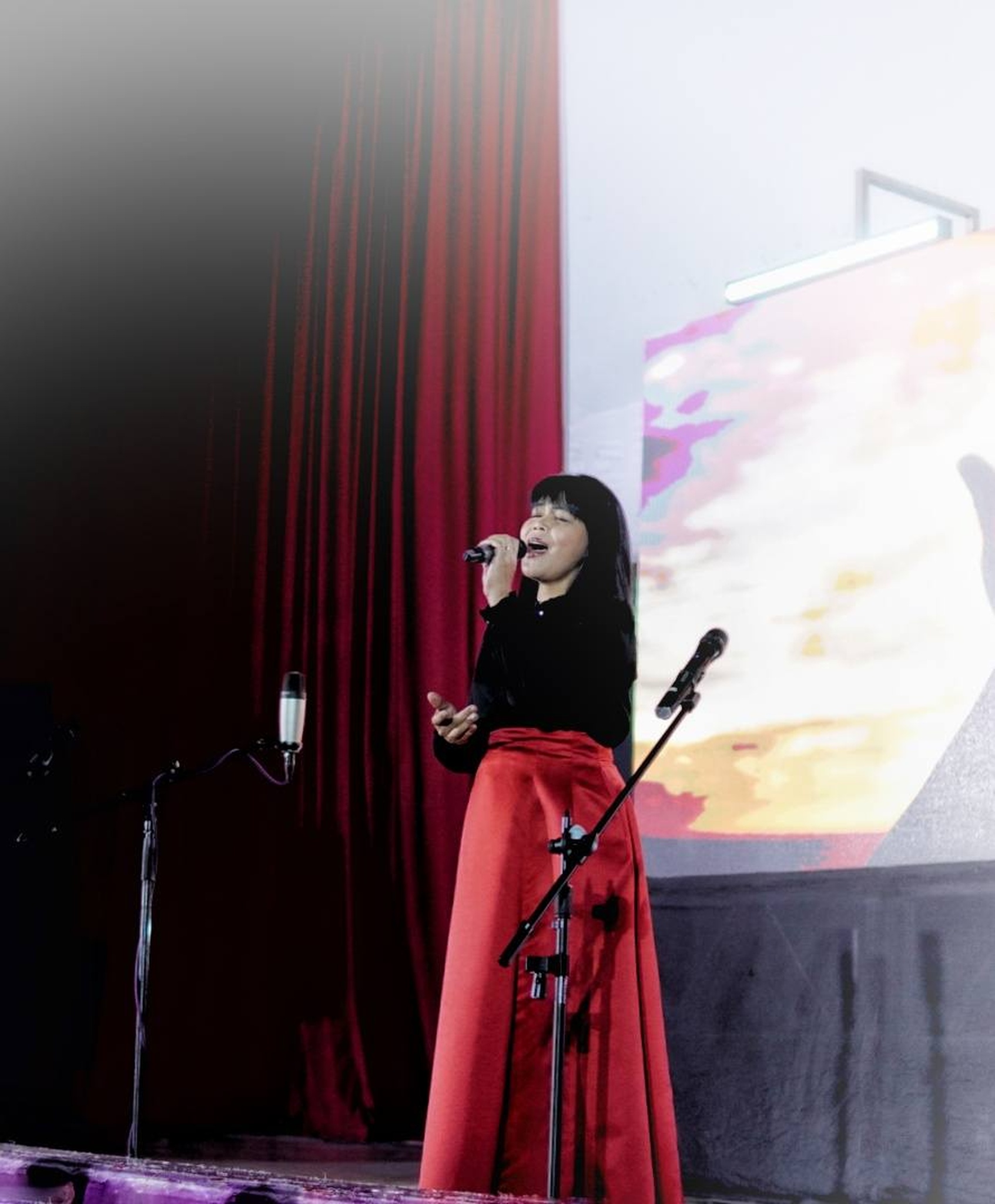 Student singing on stage