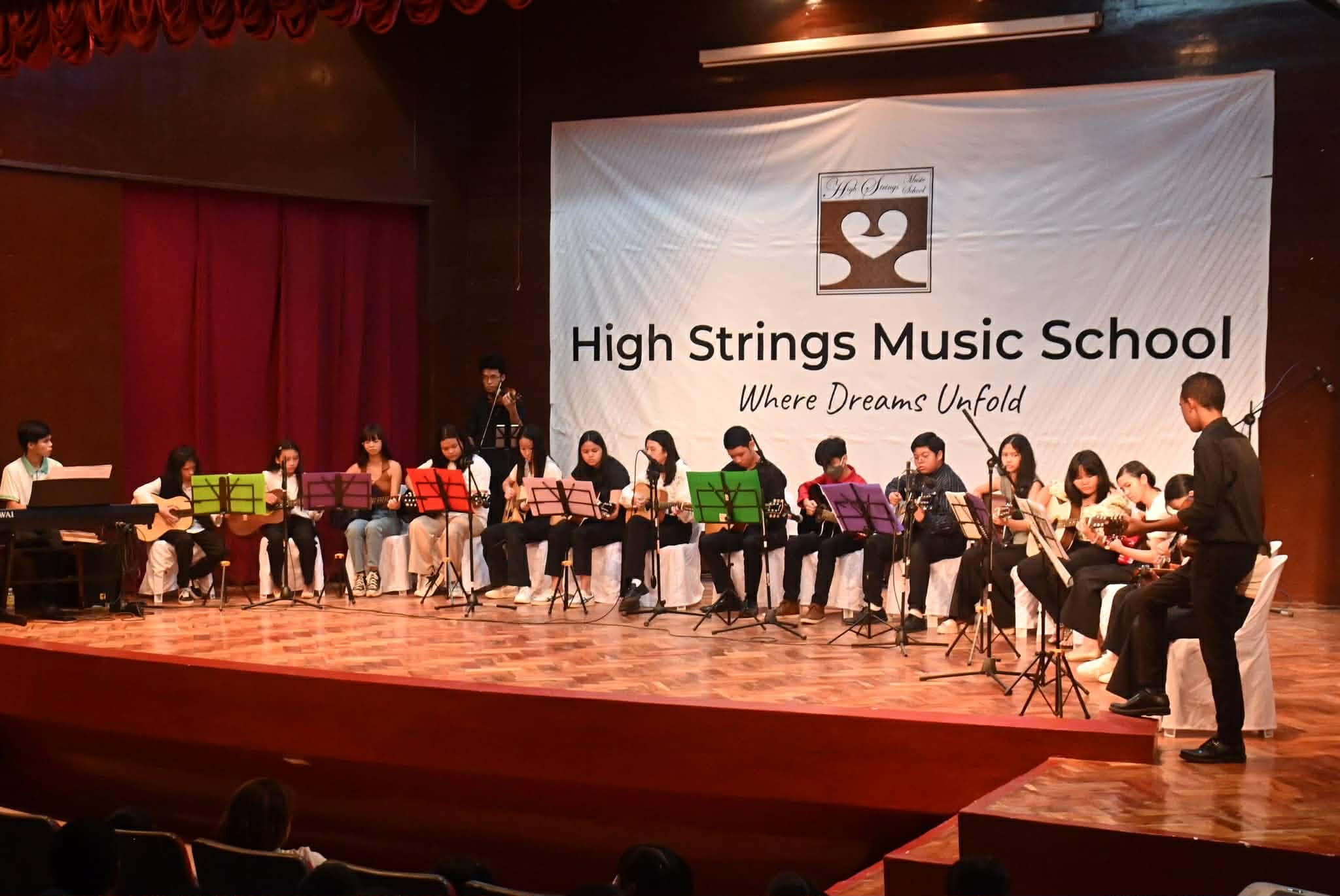 High Strings students performing at a recital on stage